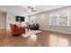Bright living room featuring hardwood floors, a ceiling fan, and natural light from large windows at 4008 Pinot Way, Fort Mill, SC 29707