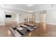Expansive living room with tray ceilings, hardwood floors, and adjacent spaces at 4008 Pinot Way, Fort Mill, SC 29707
