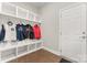 Organized mudroom with white shelving, hooks, and storage beneath, located near the entryway door at 4008 Pinot Way, Fort Mill, SC 29707