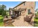 Patio with outdoor kitchen, stone fireplace, and wicker furniture perfect for entertaining at 4008 Pinot Way, Fort Mill, SC 29707