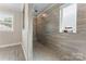 Walk-in shower featuring tiled walls, a built-in bench, and window for natural light at 4008 Pinot Way, Fort Mill, SC 29707