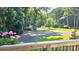 A backyard surrounded by large trees and blooming flowers at 415 S Central Ave, Locust, NC 28097