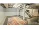 Finished basement featuring an open space and access to the stairs at 415 S Central Ave, Locust, NC 28097