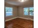 Bedroom with hardwood floors and dual windows offering ample natural light at 415 S Central Ave, Locust, NC 28097