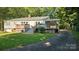 Exterior view of home featuring a large deck and beautiful lawn at 415 S Central Ave, Locust, NC 28097