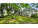 Well-maintained home featuring a lush front lawn and inviting covered porch, framed by mature trees at 415 S Central Ave, Locust, NC 28097