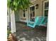 Charming front porch featuring a swing, decorative plants, and classic lanterns for relaxation at 415 S Central Ave, Locust, NC 28097