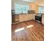 Well-lit kitchen with stainless steel appliances, decorative backsplash, and updated countertops at 415 S Central Ave, Locust, NC 28097
