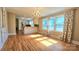 Open-concept living room flows into a modern kitchen with ample natural light from large windows at 415 S Central Ave, Locust, NC 28097
