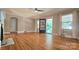 Inviting living room featuring gleaming hardwood floors, large windows, and a charming fireplace at 415 S Central Ave, Locust, NC 28097