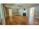 Bright living room with hardwood floors, a fireplace, and arched doorways for a cozy atmosphere at 415 S Central Ave, Locust, NC 28097