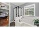 Bright bathroom features a tub with shower and a large window for natural light at 488 Saint George Rd, Fort Mill, SC 29708