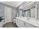 Bathroom with double sink vanity, large mirror, and white cabinets offers a clean, modern look at 488 Saint George Rd, Fort Mill, SC 29708