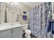 Bathroom with vanity, single sink, toilet, and shower with blue floral curtain at 488 Saint George Rd, Fort Mill, SC 29708