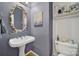 Stylish powder room features pedestal sink, decorative mirror, and coastal-inspired decor at 488 Saint George Rd, Fort Mill, SC 29708