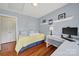 Light blue bedroom with a white desk area, twin bed, and wood floors at 488 Saint George Rd, Fort Mill, SC 29708