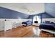 Spacious bedroom with wood floors, wainscoting, and beds with blue bedding at 488 Saint George Rd, Fort Mill, SC 29708
