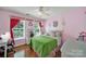Charming pink bedroom with a green quilt bed, desk, and sunny windows at 488 Saint George Rd, Fort Mill, SC 29708