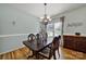 Formal dining room features hardwood floors, elegant chandelier, and traditional wood furniture at 488 Saint George Rd, Fort Mill, SC 29708