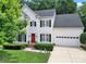 Charming two-story home boasts a well-manicured lawn, black shutters, and a vibrant red front door at 488 Saint George Rd, Fort Mill, SC 29708