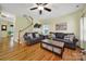 Spacious living room with hardwood floors, comfortable sofas, and staircase leading to the upper level at 488 Saint George Rd, Fort Mill, SC 29708