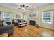Bright living room featuring hardwood floors, fireplace, comfortable seating, and natural light at 488 Saint George Rd, Fort Mill, SC 29708