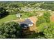 Aerial view showing the back of the white farmhouse with large trees on a sprawling property at 5015 Lancaster Hwy, Monroe, NC 28112