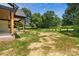 Expansive backyard featuring a well-maintained lawn and a covered patio, creating an inviting outdoor space at 5015 Lancaster Hwy, Monroe, NC 28112