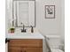 Bathroom featuring a wood vanity, quartz countertop, and a framed mirror to bring the room together at 5015 Lancaster Hwy, Monroe, NC 28112