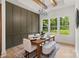 Bright dining room offers seating for six, modern chandelier, and an excellent view of the backyard at 5015 Lancaster Hwy, Monroe, NC 28112