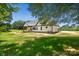 Exterior view of the home highlighting its white siding, black trim, and expansive yard at 5015 Lancaster Hwy, Monroe, NC 28112