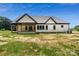 Rear exterior view showcasing the home's covered patio, white siding, black trim, and large windows at 5015 Lancaster Hwy, Monroe, NC 28112