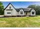 Inviting white farmhouse with black accents, well-manicured lawn, and a welcoming entrance at 5015 Lancaster Hwy, Monroe, NC 28112
