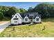 Beautiful modern farmhouse with black accents, a manicured lawn, and a private wooded backdrop at 5015 Lancaster Hwy, Monroe, NC 28112