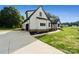 Gorgeous new farmhouse with a long concrete driveway, a side-entry garage and pristine landscaping at 5015 Lancaster Hwy, Monroe, NC 28112
