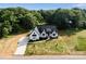 Newly constructed white farmhouse with black trim on a large lot with verdant landscaping at 5015 Lancaster Hwy, Monroe, NC 28112