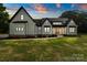 Charming farmhouse with a modern design, featuring black framed windows and well-maintained lawn at 5015 Lancaster Hwy, Monroe, NC 28112