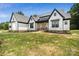 Charming modern farmhouse with white siding, black trim, and a covered front porch at 5015 Lancaster Hwy, Monroe, NC 28112