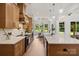 Gourmet kitchen with quartz countertops, stainless steel appliances, and custom cabinetry and eat-in dining area at 5015 Lancaster Hwy, Monroe, NC 28112