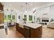 Well-lit kitchen island overlooks the open floor plan, dining, and living room with a fireplace at 5015 Lancaster Hwy, Monroe, NC 28112