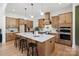 Open concept kitchen boasts a large island with seating and modern appliances, perfect for entertaining guests at 5015 Lancaster Hwy, Monroe, NC 28112
