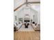 Bright living room with a fireplace, modern lighting, and hardwood floors, perfect for entertaining or relaxing at 5015 Lancaster Hwy, Monroe, NC 28112
