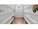 Walk-in pantry features white shelving for ample storage space and a window for natural light at 5015 Lancaster Hwy, Monroe, NC 28112