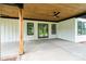 Covered outdoor patio with ceiling fans, concrete flooring, and wooden support beams, offering scenic views at 5015 Lancaster Hwy, Monroe, NC 28112