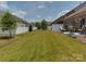 Green backyard with lawn, white fence and patio seating that provides an ideal space for outdoor relaxation at 5020 Forest Hills Pl, Fort Mill, SC 29707