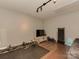 Basement space set up as a home gym with weights and a TV for fitness and entertainment at 5020 Forest Hills Pl, Fort Mill, SC 29707