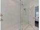 Glass walk-in shower with a dual shower head and modern fixtures at 5020 Forest Hills Pl, Fort Mill, SC 29707