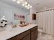 Bathroom boasts a double vanity, quartz countertops, with white cabinets and modern fixtures at 5020 Forest Hills Pl, Fort Mill, SC 29707