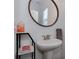 Powder room with a pedestal sink and decorative mirror, perfect for guests at 5020 Forest Hills Pl, Fort Mill, SC 29707