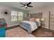 Cozy bedroom showcasing a plush bed, large windows, and stylish decor for a comfortable retreat at 5020 Forest Hills Pl, Fort Mill, SC 29707